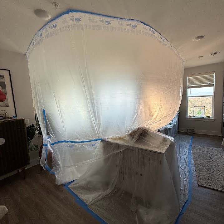 Sealed dust containment setup protecting a room during drywall work