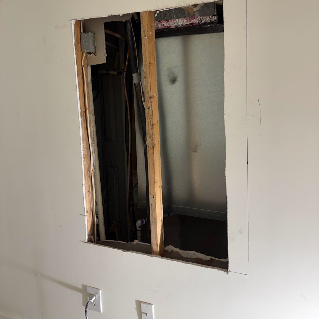 Wall access cut before HVAC post-trade repair